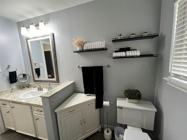 bathroom featuring toilet, tile patterned floors, and vanity