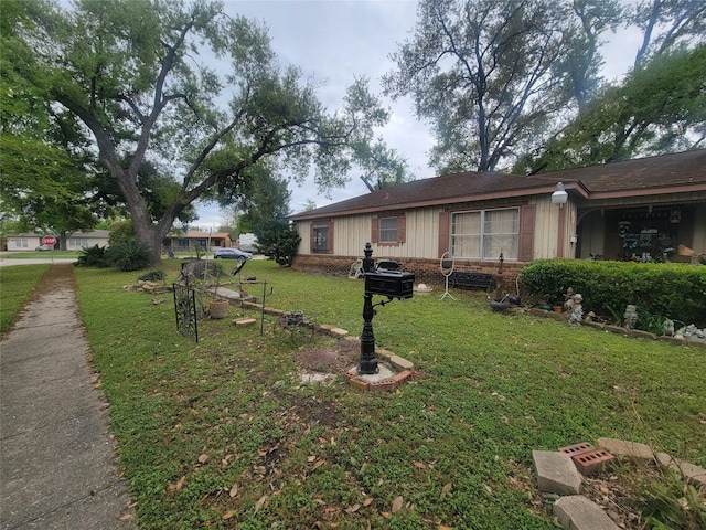 view of front of property with a front yard and brick siding