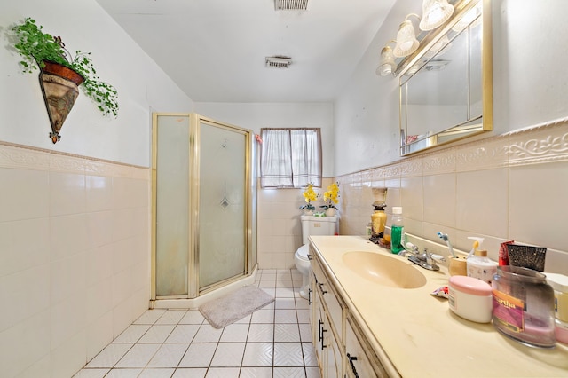 full bath featuring tile walls, a shower stall, vanity, tile patterned floors, and visible vents