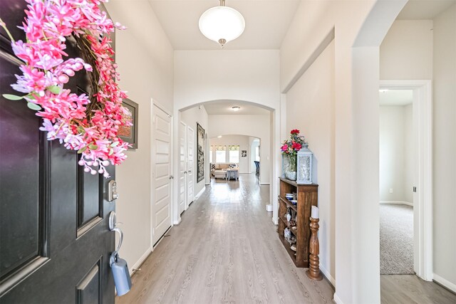13710 Alaskan Brown Bear Trl, Crosby, TX 77532 - foyer with baseboards, arched walkways, and wood finished floors