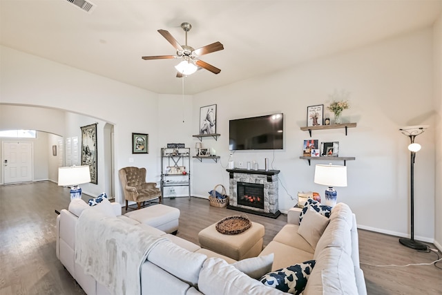 13710 Alaskan Brown Bear Trl, Crosby, TX 77532 - living room with wood finished floors, arched walkways, a fireplace, visible vents, and a ceiling fan