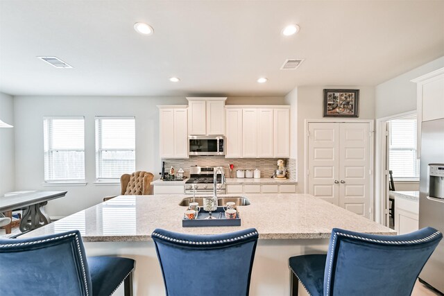 13710 Alaskan Brown Bear Trl, Crosby, TX 77532 - kitchen with a wealth of natural light, backsplash, appliances with stainless steel finishes, and a sink