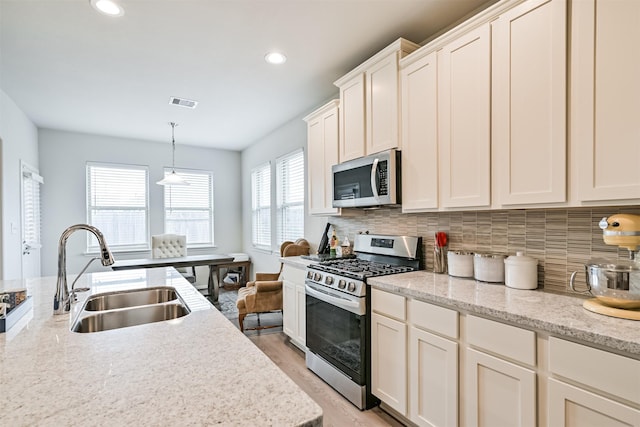 13710 Alaskan Brown Bear Trl, Crosby, TX 77532 - kitchen featuring visible vents, tasteful backsplash, appliances with stainless steel finishes, and a sink