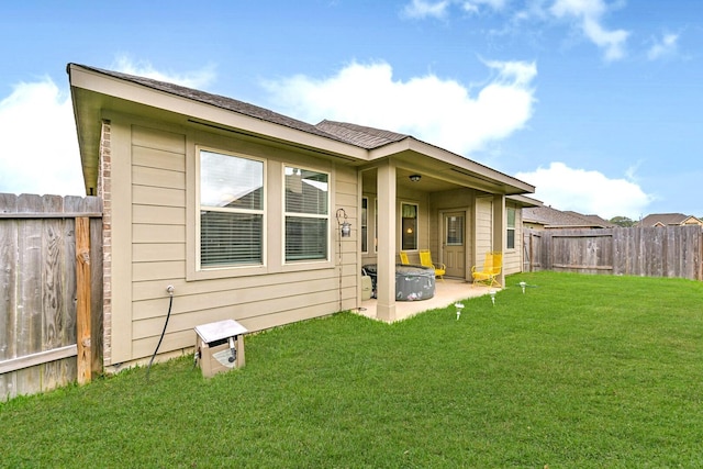 13710 Alaskan Brown Bear Trl, Crosby, TX 77532 - back of property featuring a lawn, a fenced backyard, and a patio area
