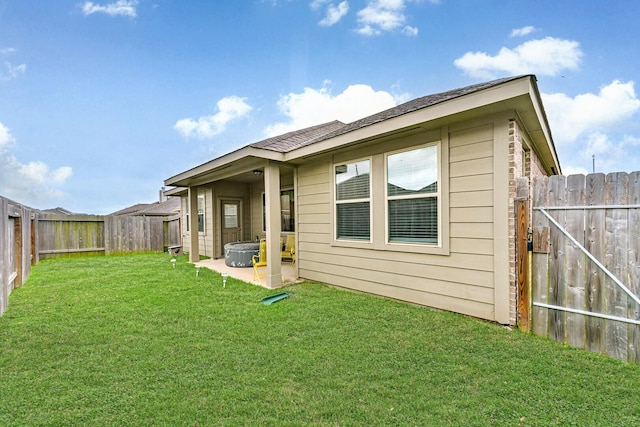 13710 Alaskan Brown Bear Trl, Crosby, TX 77532 - rear view of house featuring a yard, a fenced backyard, and a patio area