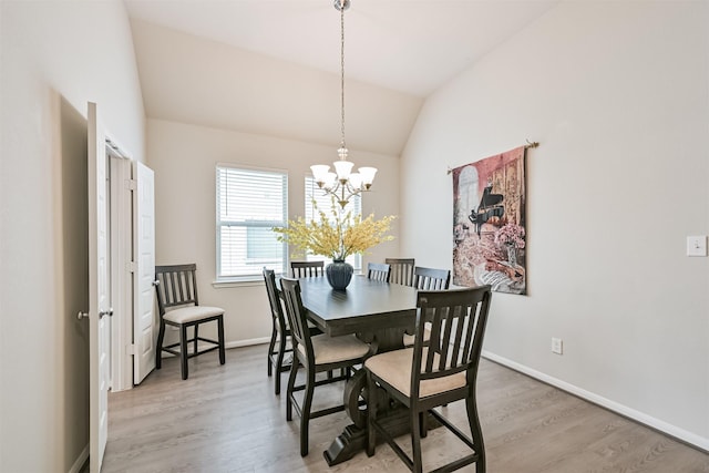 13710 Alaskan Brown Bear Trl, Crosby, TX 77532 - dining space featuring baseboards, wood finished floors, a notable chandelier, and vaulted ceiling