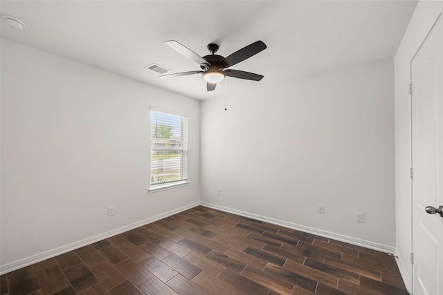 unfurnished room featuring dark wood-type flooring, baseboards, ceiling fan, and visible vents