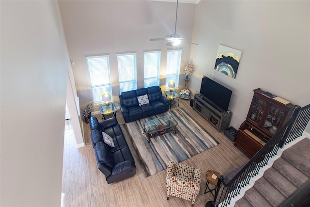 1627 Carriage Oaks Ln, Katy, TX 77494 - living area featuring baseboards, a high ceiling, a ceiling fan, and wood finished floors