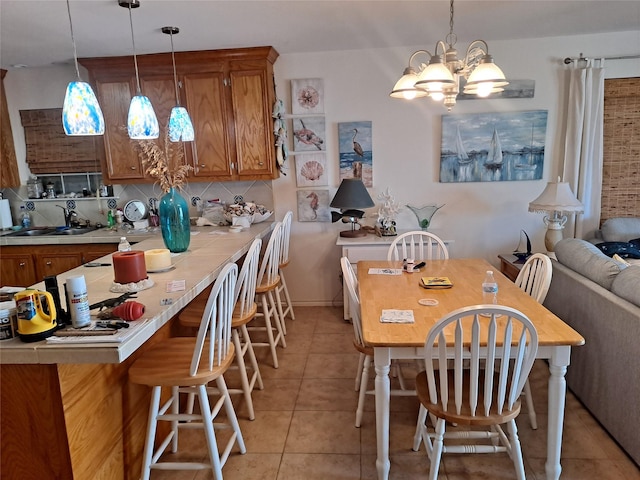 dining area with light tile patterned floors and a notable chandelier