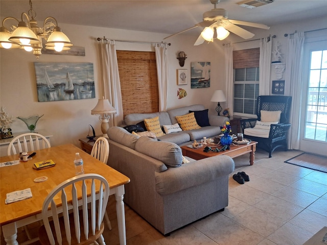tiled living room with ceiling fan with notable chandelier and visible vents