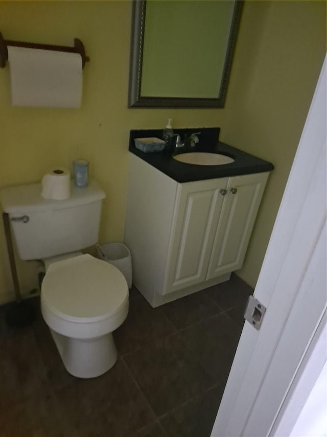 bathroom featuring toilet, tile patterned flooring, and vanity