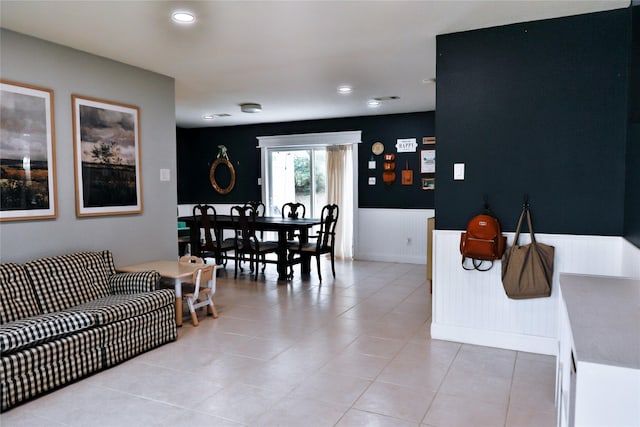 living room featuring wainscoting, recessed lighting, and light tile patterned floors