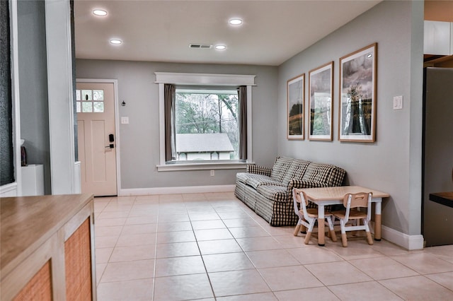 interior space with light tile patterned flooring, baseboards, visible vents, and recessed lighting