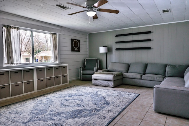 living area with tile patterned floors, ceiling fan, and visible vents