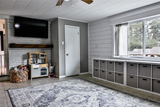 interior space with tile patterned floors, baseboards, and a ceiling fan