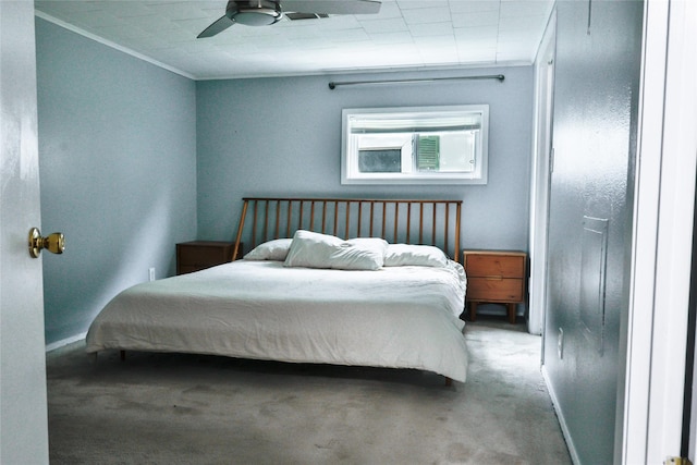 carpeted bedroom featuring baseboards, ornamental molding, and a ceiling fan
