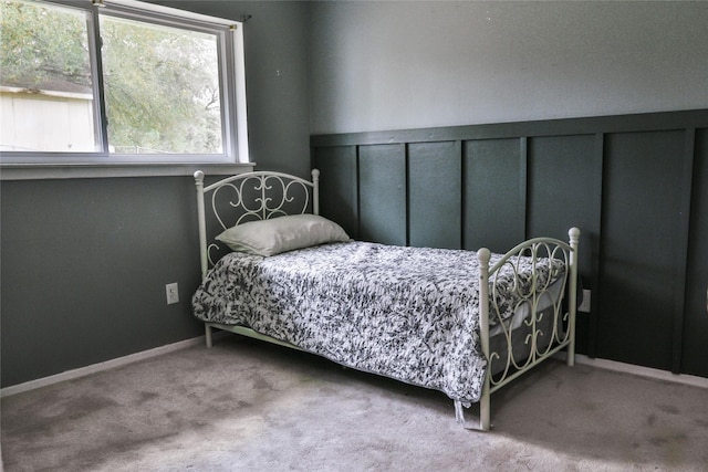 bedroom featuring baseboards and carpet flooring