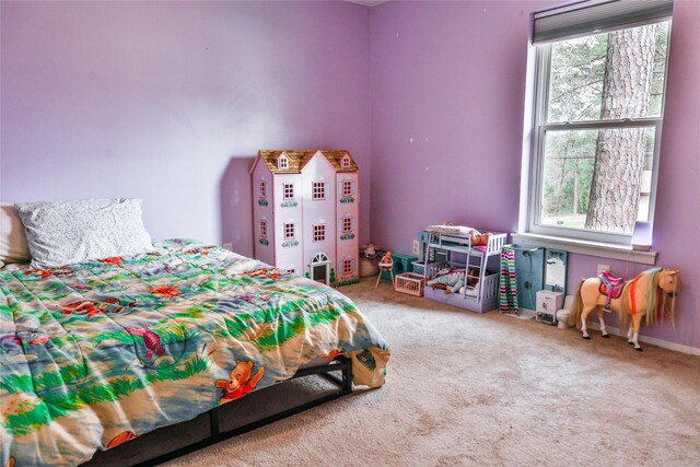 bedroom featuring baseboards and carpet floors