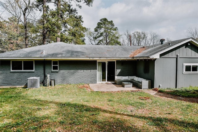rear view of house with central air condition unit, an outdoor living space, a patio area, and a lawn