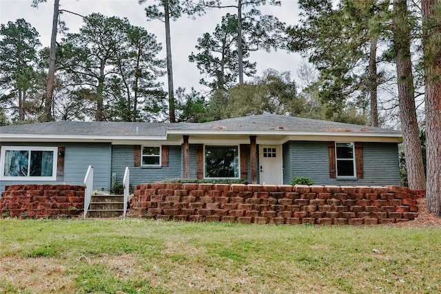 ranch-style home featuring a front yard