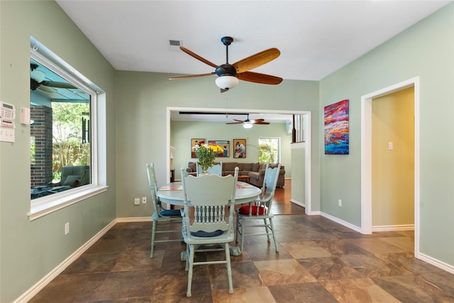 12510 Beauline Abbey St, Tomball, TX 77377 - dining area featuring stone finish flooring, baseboards, visible vents, and ceiling fan