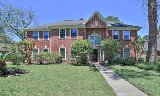 12510 Beauline Abbey St, Tomball, TX 77377 - view of front of house with roof with shingles, a front lawn, and brick siding