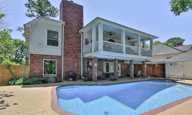 12510 Beauline Abbey St, Tomball, TX 77377 - back of house with a balcony, brick siding, fence, ceiling fan, and a patio area