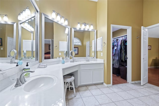 12510 Beauline Abbey St, Tomball, TX 77377 - bathroom with tile patterned floors, double vanity, a spacious closet, and a sink