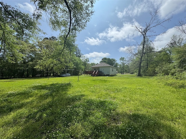 208 County Road 308, Cleveland, TX 77327 - view of yard featuring a wooden deck