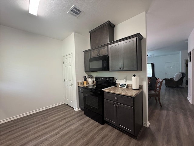 208 County Road 308, Cleveland, TX 77327 - kitchen featuring dark wood finished floors, baseboards, black appliances, and visible vents