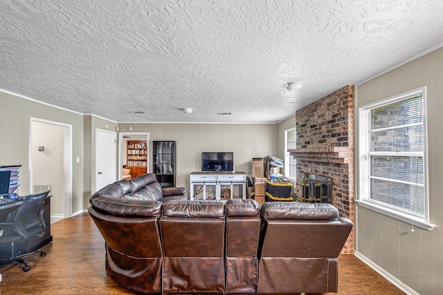 3102 Blue Hills Dr, Missouri City, TX 77459 - living room featuring baseboards, a textured ceiling, visible vents, a fireplace, and wood finished floors