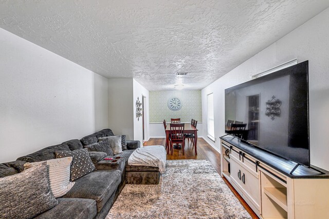 3102 Blue Hills Dr, Missouri City, TX 77459 - living room featuring a textured ceiling, baseboards, and dark wood finished floors