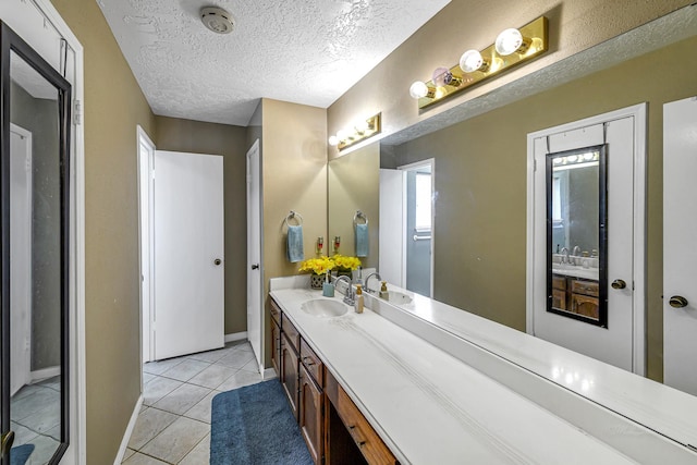 3102 Blue Hills Dr, Missouri City, TX 77459 - bathroom featuring tile patterned floors, baseboards, vanity, and a textured ceiling