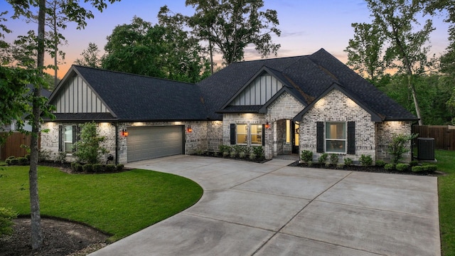 2711 Constantine St, New Caney, TX 77357 - view of front of home with board and batten siding, concrete driveway, an attached garage, brick siding, and a shingled roof