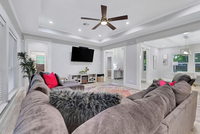 2711 Constantine St, New Caney, TX 77357 - living room featuring ceiling fan, healthy amount of natural light, a tray ceiling, recessed lighting, and baseboards