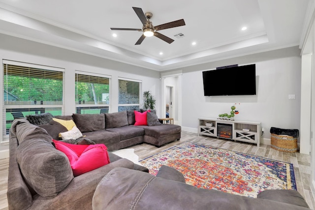2711 Constantine St, New Caney, TX 77357 - living area with ceiling fan, a tray ceiling, wood finished floors, baseboards, and recessed lighting