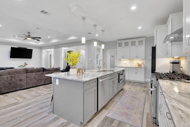 2711 Constantine St, New Caney, TX 77357 - kitchen featuring appliances with stainless steel finishes, under cabinet range hood, a sink, a ceiling fan, and recessed lighting
