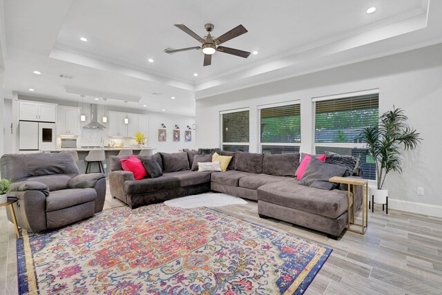 2711 Constantine St, New Caney, TX 77357 - living room featuring a raised ceiling, ceiling fan, recessed lighting, baseboards, and crown molding