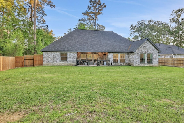 2711 Constantine St, New Caney, TX 77357 - back of property featuring a patio area, brick siding, and a shingled roof
