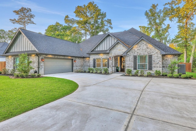2711 Constantine St, New Caney, TX 77357 - view of front of house with board and batten siding, brick siding, driveway, a front lawn, and a shingled roof