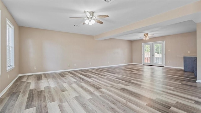 1302 20th St, Huntsville, TX 77340 - unfurnished living room featuring ceiling fan, wood finished floors, and baseboards