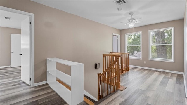 1302 20th St, Huntsville, TX 77340 - hallway featuring an upstairs landing, wood finished floors, and baseboards