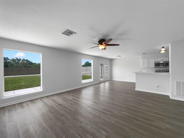 19431 Cypress Royal Dr, Katy, TX 77449 - unfurnished living room with healthy amount of natural light, ceiling fan, baseboards, and dark wood-type flooring