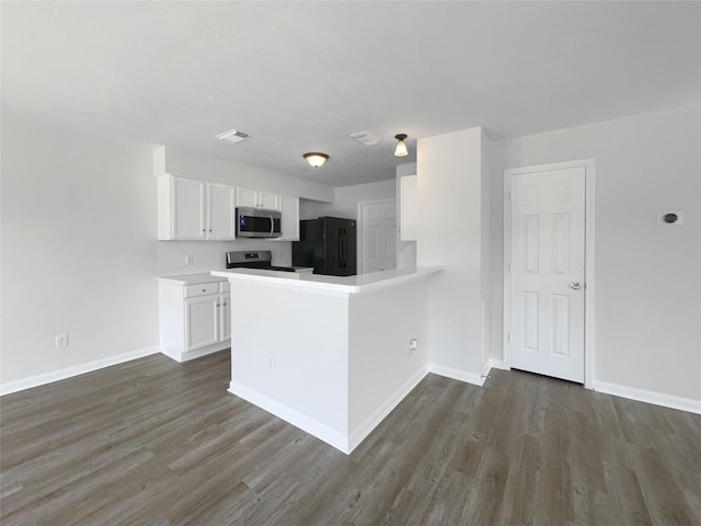 19431 Cypress Royal Dr, Katy, TX 77449 - kitchen featuring stainless steel appliances, white cabinets, dark wood-type flooring, and baseboards