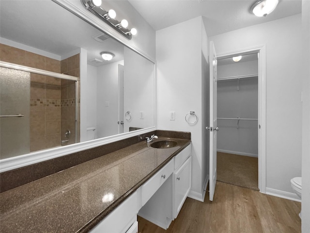 19431 Cypress Royal Dr, Katy, TX 77449 - full bath featuring toilet, tiled shower, wood finished floors, and vanity