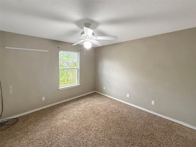 empty room with carpet, a textured ceiling, baseboards, and ceiling fan