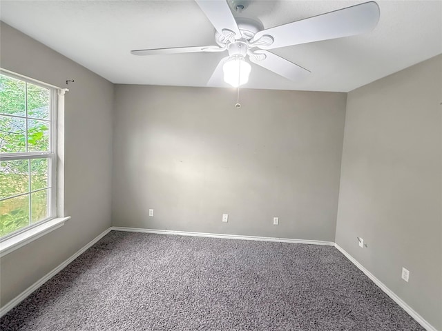 spare room featuring baseboards, a ceiling fan, and carpet