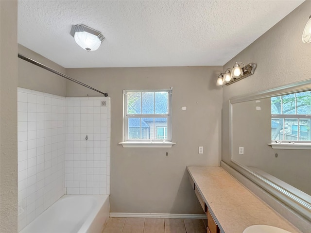 full bathroom with baseboards, a textured ceiling, shower / tub combination, and vanity