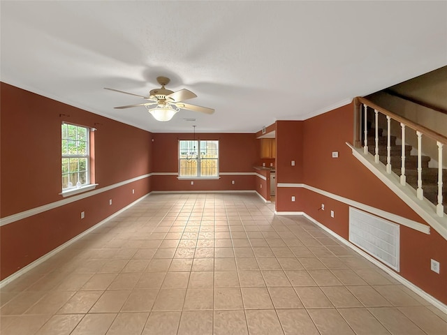 empty room featuring baseboards, visible vents, light tile patterned floors, and a ceiling fan