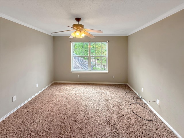carpeted empty room featuring a textured ceiling, ceiling fan, baseboards, and crown molding